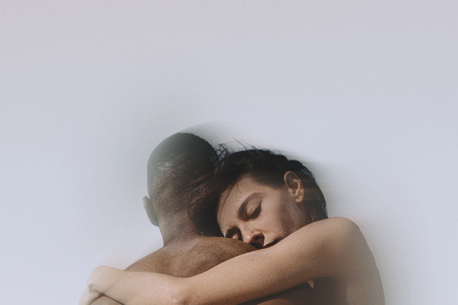 Two people held in a close embrace.